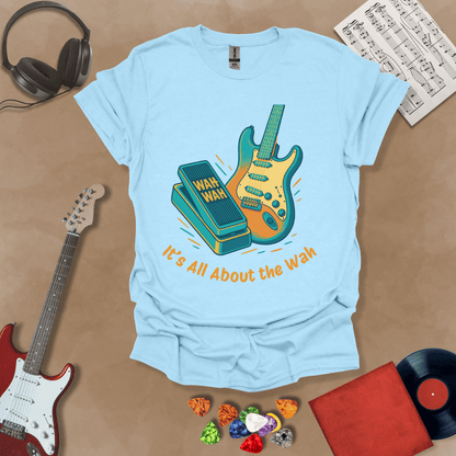 Light blue t-shirt with bright color graphic guitar and wah wah pedal with text "It's all about the wah". 