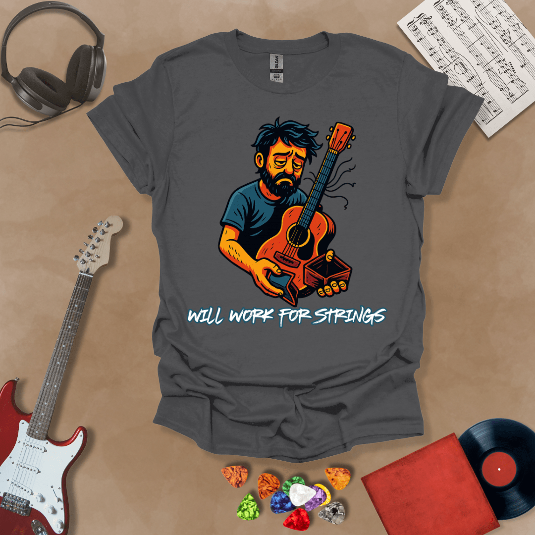  Gray t-shirt with a graphic of Cartoon-style illustration of a scruffy man holding a broken guitar and an empty wallet, looking sad. and text 'Will work for strings' .
