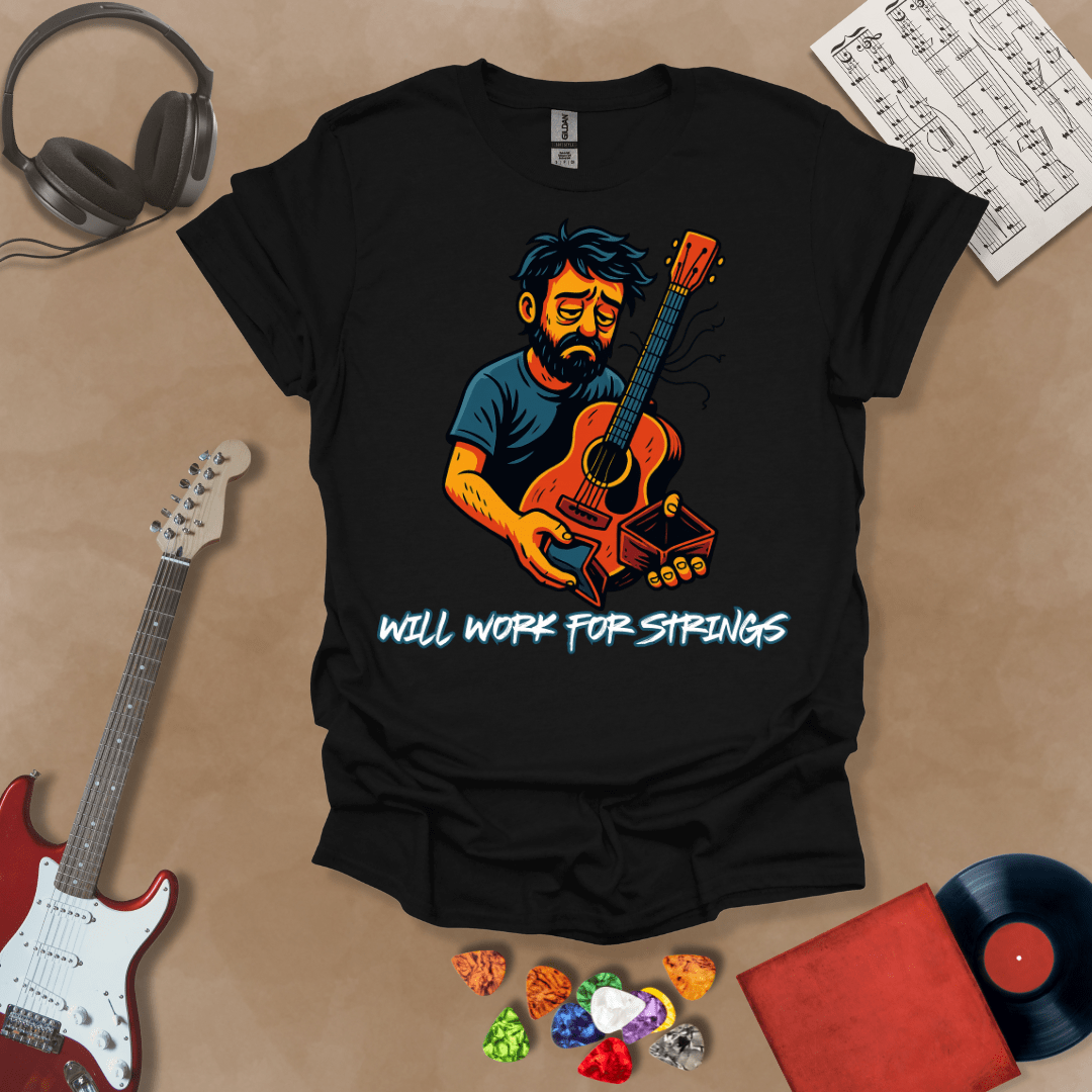 Black t-shirt with a graphic of Cartoon-style illustration of a scruffy man holding a broken guitar and an empty wallet, looking sad. and text 'Will work for strings' .
