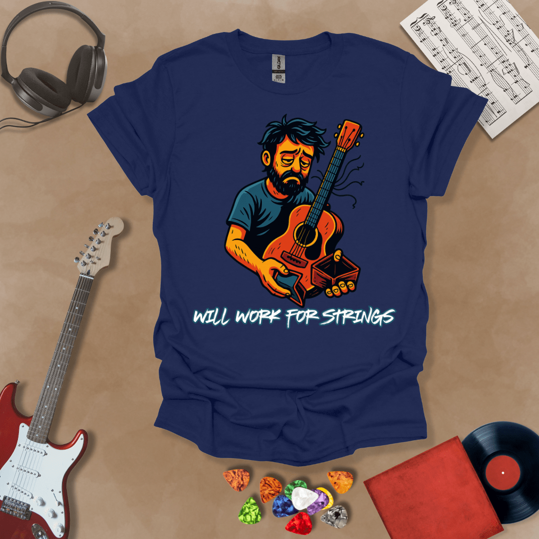 Navy t-shirt with a graphic of Cartoon-style illustration of a scruffy man holding a broken guitar and an empty wallet, looking sad. and text 'Will work for strings' .