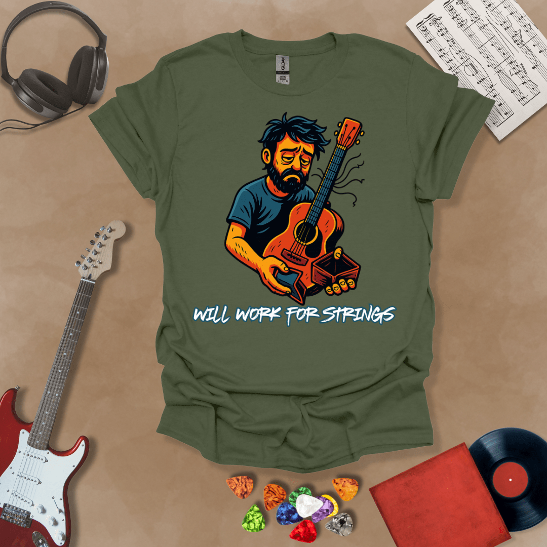 Green t-shirt with a graphic of Cartoon-style illustration of a scruffy man holding a broken guitar and an empty wallet, looking sad. and text 'Will work for strings' .