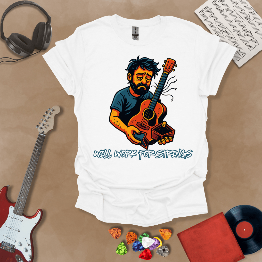 White t-shirt with a graphic of Cartoon-style illustration of a scruffy man holding a broken guitar and an empty wallet, looking sad. and text 'Will work for strings' .