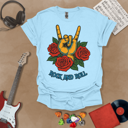 Light Blue t-shirt with orange hand in devil horns gesture, surrounded by red roses, text “Rock and Roll.”