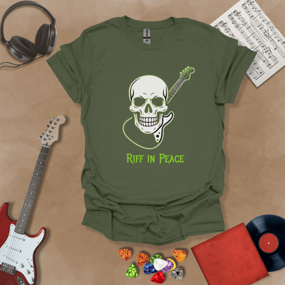 Green t-shirt with neon green skull graphic holding guitar neck, text “Riff in Peace.”