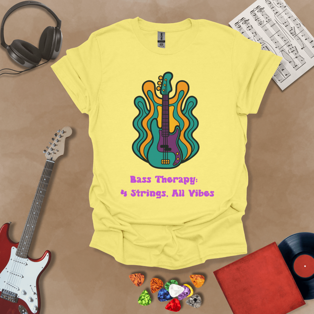 Yellow t-shirt with psychedelic-style bass guitar illustration, colorful wavy accents, text “Bass Therapy: 4 Strings, All Vibes