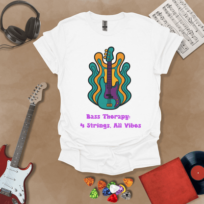 White t-shirt with psychedelic-style bass guitar illustration, colorful wavy accents, text “Bass Therapy: 4 Strings, All Vibes