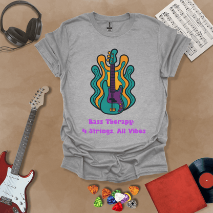 Gray t-shirt with psychedelic-style bass guitar illustration, colorful wavy accents, text “Bass Therapy: 4 Strings, All Vibes