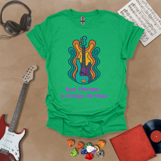 Green t-shirt with psychedelic-style bass guitar illustration, colorful wavy accents, text “Bass Therapy: 4 Strings, All Vibes.”