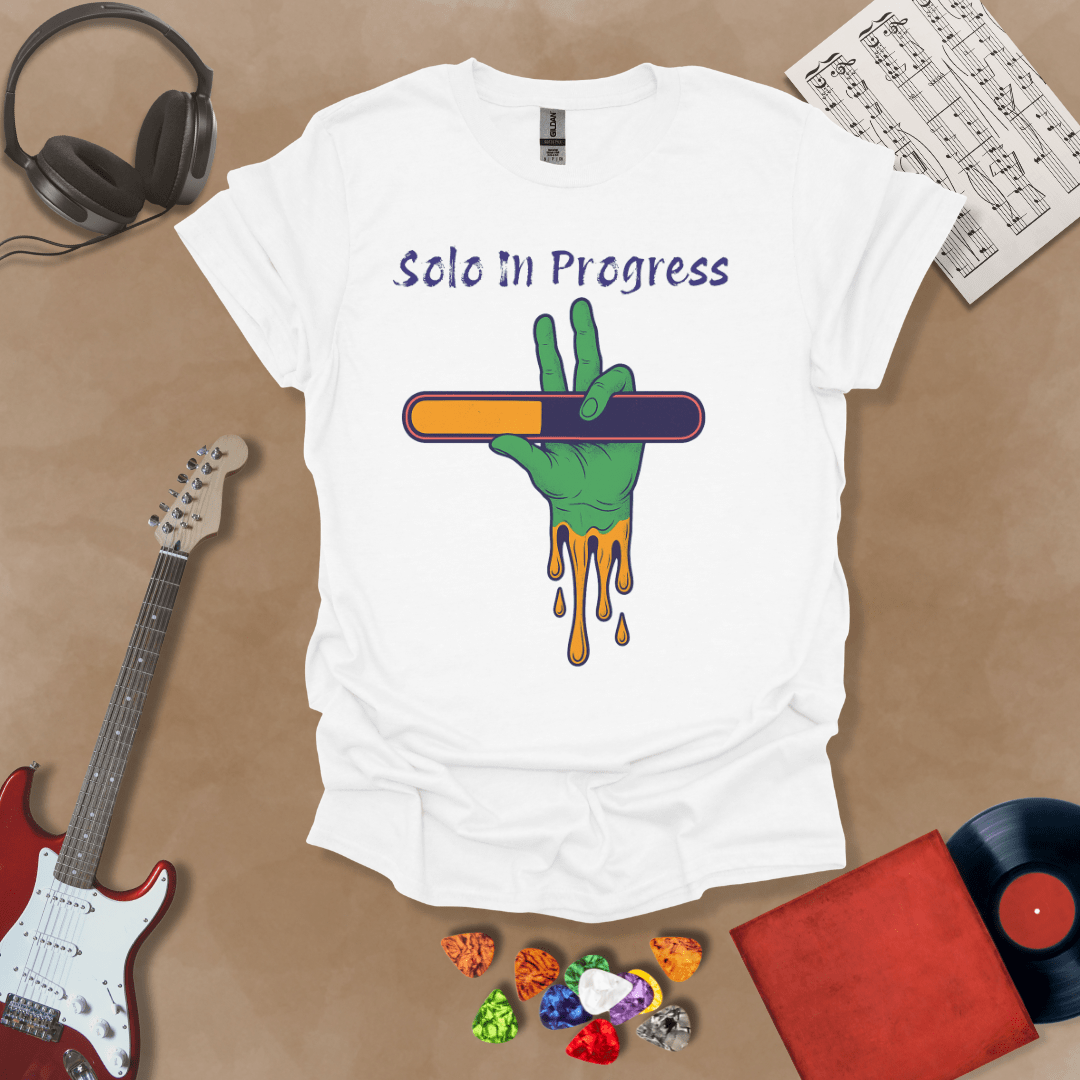 White t-shirt with green zombie-like hand holding a colorful loading bar, text “Solo in Progress.”