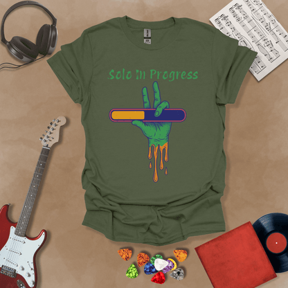 Green t-shirt with green zombie-like hand holding a colorful loading bar, text “Solo in Progress.”