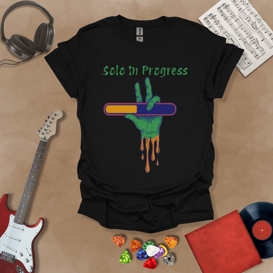 Black t-shirt with green zombie-like hand holding a colorful loading bar, text “Solo in Progress.”