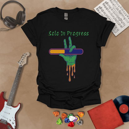 Black t-shirt with green zombie-like hand holding a colorful loading bar, text “Solo in Progress.”