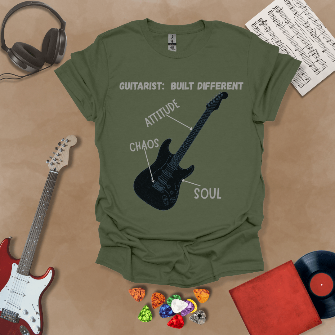 Green t-shirt with black electric guitar diagram labeled “Attitude, Chaos, Soul,” text “Guitarist: Built Different.”