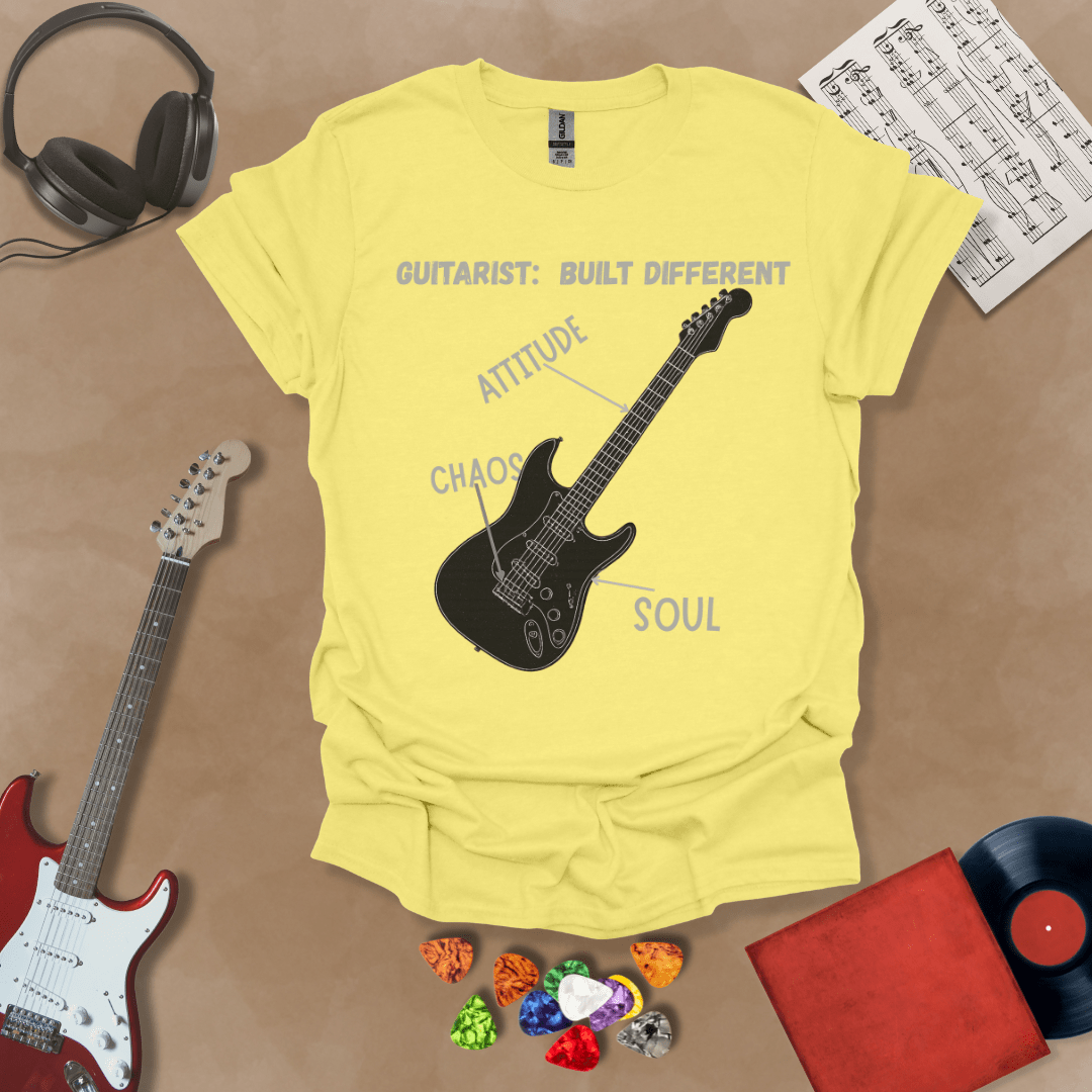 Yellow t-shirt with black electric guitar diagram labeled “Attitude, Chaos, Soul,” text “Guitarist: Built Different.”