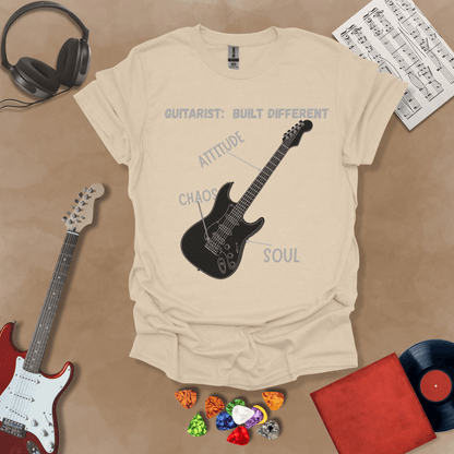 Beige t-shirt with black electric guitar diagram labeled “Attitude, Chaos, Soul,” text “Guitarist: Built Different.”