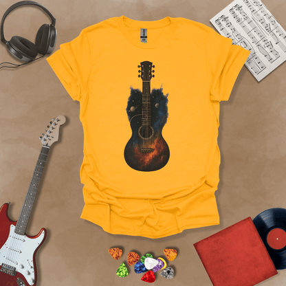 Yellow t-shirt with acoustic guitar body filled with galaxy space design, planets and stars visible.