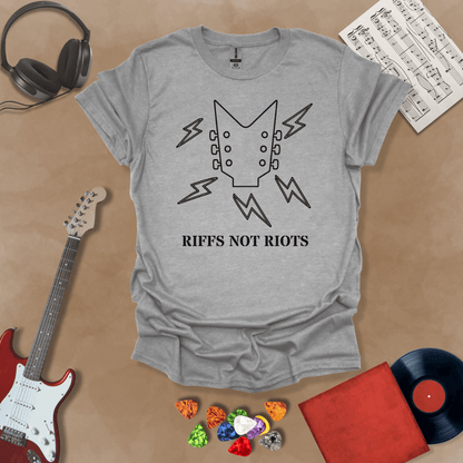 Gray t-shirt with black outline of guitar headstock and black lightning bolts, text “Riffs Not Riots.”