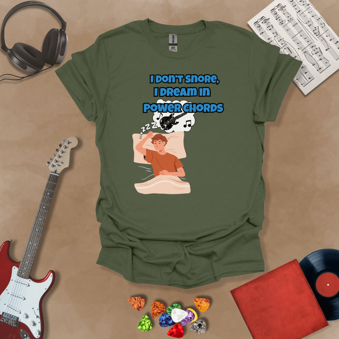 Green sleeping person, dream bubble with guitar, text “I Don’t Snore, I Dream in Power Chords.”