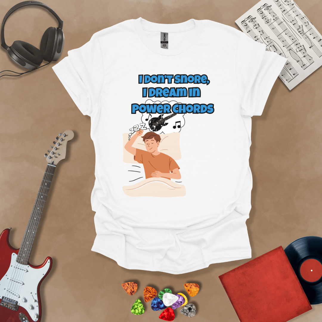 White sleeping person, dream bubble with guitar, text “I Don’t Snore, I Dream in Power Chords.”