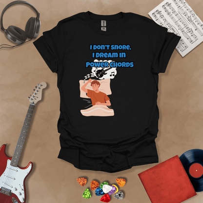 Black sleeping person, dream bubble with guitar, text “I Don’t Snore, I Dream in Power Chords.”