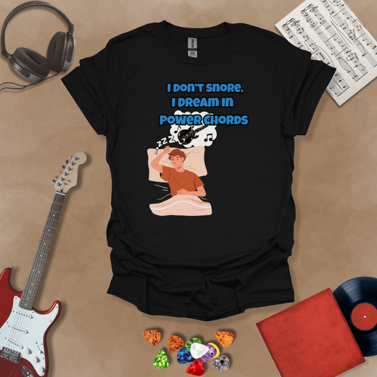Black sleeping person, dream bubble with guitar, text “I Don’t Snore, I Dream in Power Chords.”