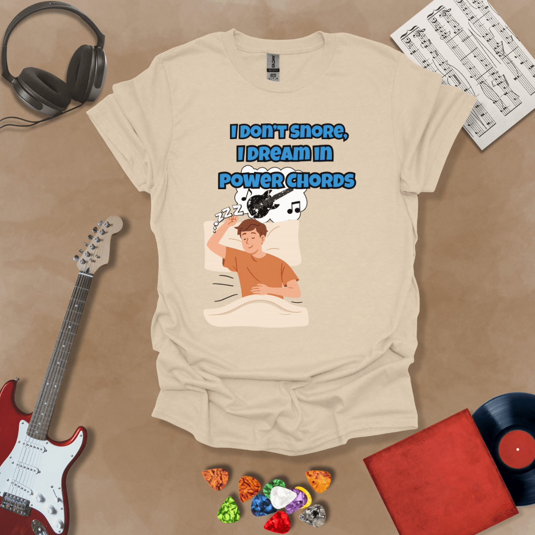 Beige sleeping person, dream bubble with guitar, text “I Don’t Snore, I Dream in Power Chords.”