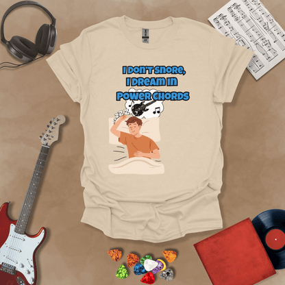 Beige sleeping person, dream bubble with guitar, text “I Don’t Snore, I Dream in Power Chords.”