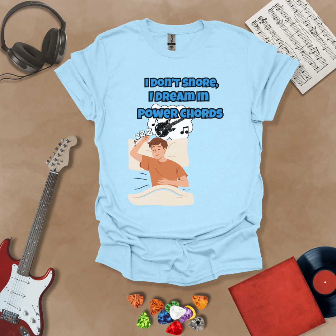 Light Blue sleeping person, dream bubble with guitar, text “I Don’t Snore, I Dream in Power Chords.”