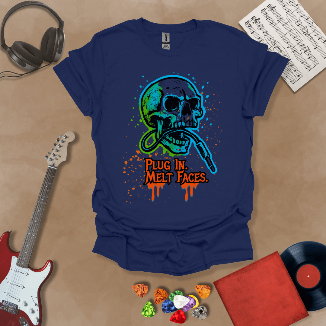 Navy t-shirt with neon-colored skull biting a guitar cable, paint splatter effect, text “Plug In. Melt Faces.”