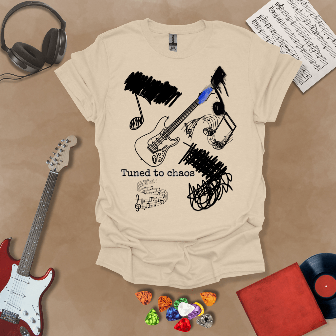 Beige t-shirt with Grunge-style electric guitar design with chaotic abstract lines and the phrase “Tuned to Chaos,” optimized for light shirts like white and sand.
