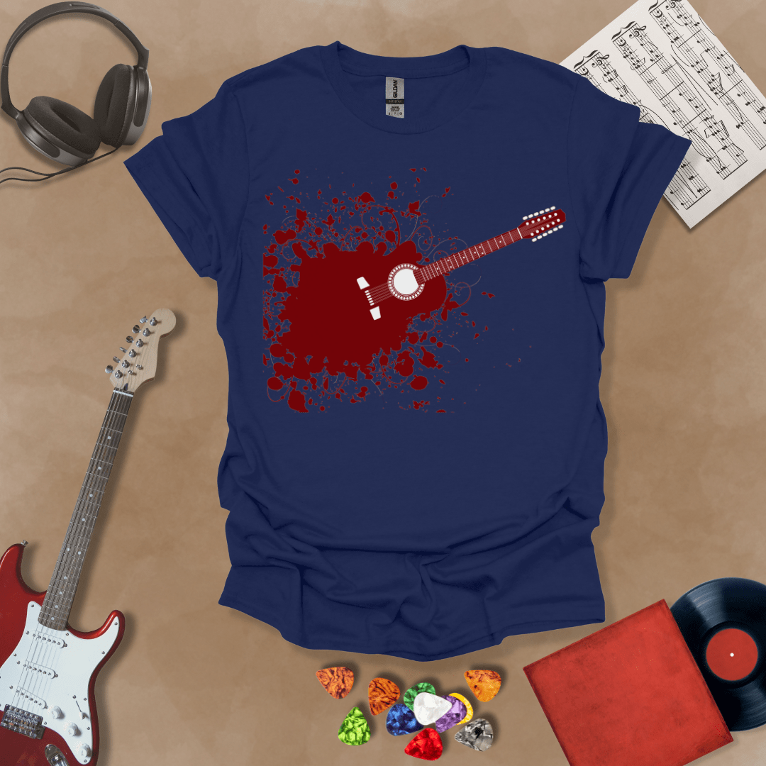 Blue t-shirt with Abstract splatter-style electric guitar design with six strings exploding outward, bold and edgy graphic.