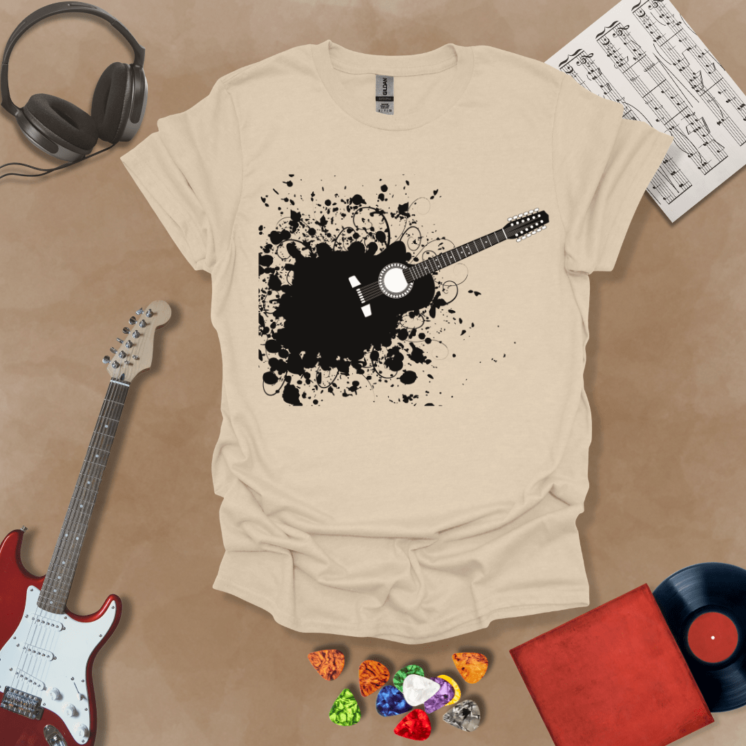 Beige t-shirt with Abstract splatter-style electric guitar design with six strings exploding outward, bold and edgy graphic.