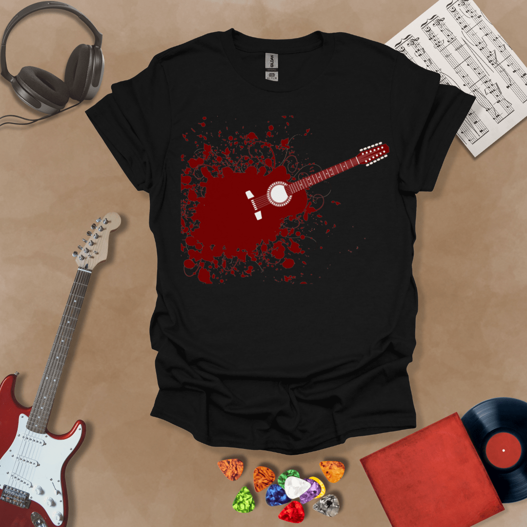 Black t-shirt with Abstract splatter-style electric guitar design with six strings exploding outward, bold and edgy graphic.