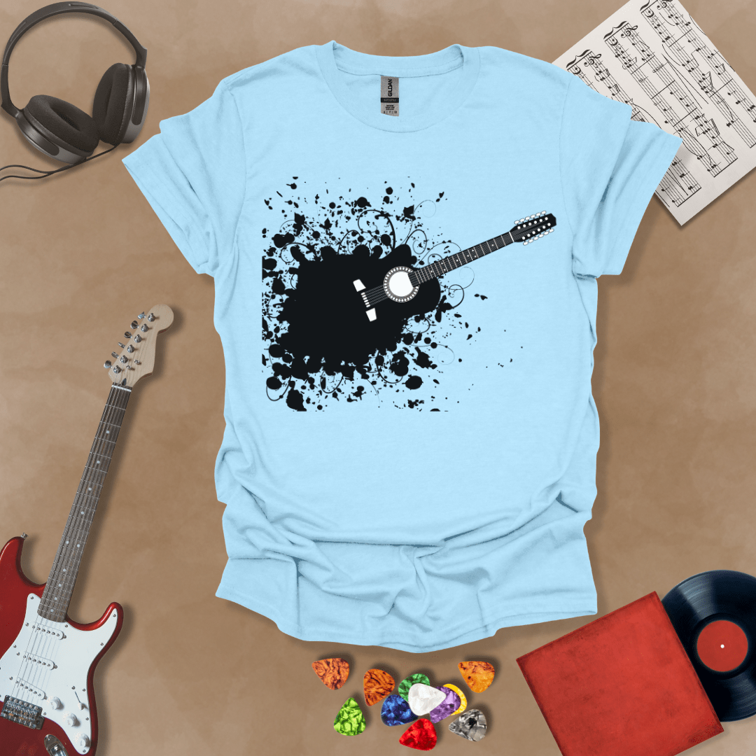 Light blue t-shirt with Abstract splatter-style electric guitar design with six strings exploding outward, bold and edgy graphic.