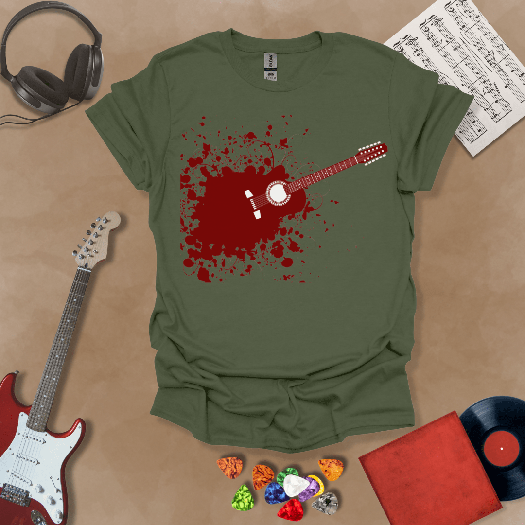 Green t-shirt with Abstract splatter-style electric guitar design with six strings exploding outward, bold and edgy graphic.
