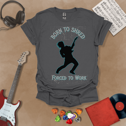 Gray t-shirt with Silhouette of a guitarist rocking out with glowing neon accents, framed by the text 'Born to Shred, Forced to Work' in bold distressed lettering.