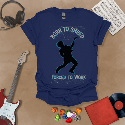 Navy t-shirt with Silhouette of a guitarist rocking out with glowing neon accents, framed by the text 'Born to Shred, Forced to Work' in bold distressed lettering.