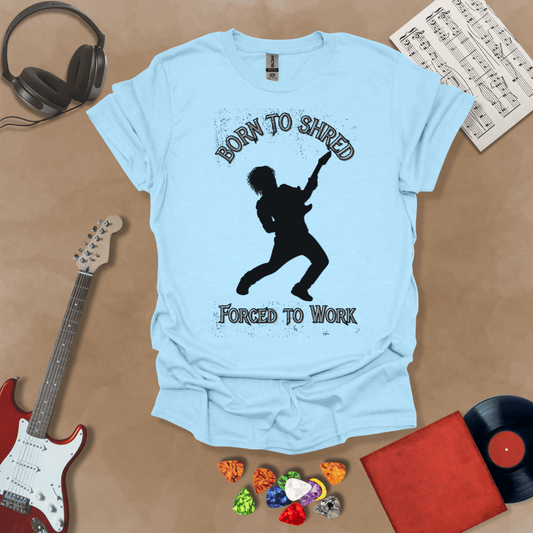 Light Blue t-shirt with Silhouette of a guitarist rocking out with glowing accents, framed by the text 'Born to Shred, Forced to Work' in bold distressed lettering.