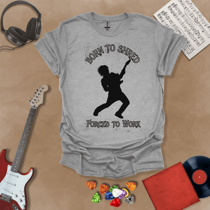 Gray t-shirt with Silhouette of a guitarist rocking out with glowing accents, framed by the text 'Born to Shred, Forced to Work' in bold distressed lettering.