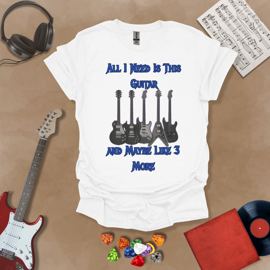 White t-shirt with Row of five electric guitars with neon glow accents under bold blue text reading ‘All I Need Is This Guitar and Maybe Like 3 More,’ rock-inspired graphic t-shirt design