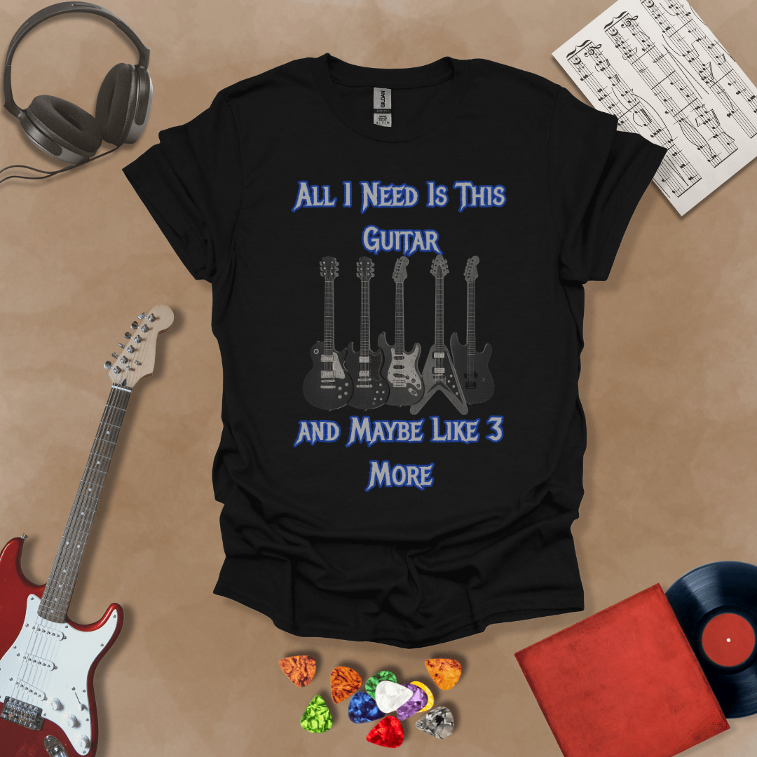 Black t-shirt with Row of five electric guitars under bold blue text reading ‘All I Need Is This Guitar and Maybe Like 3 More,’ rock-inspired graphic t-shirt design