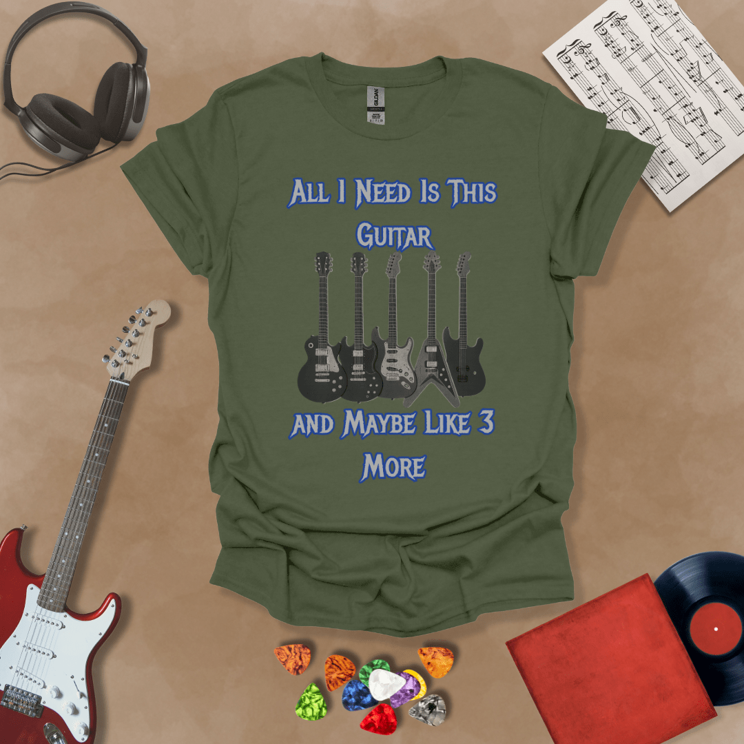 Green t-shirt with Row of five electric guitars under bold blue text reading ‘All I Need Is This Guitar and Maybe Like 3 More,’ rock-inspired graphic t-shirt design