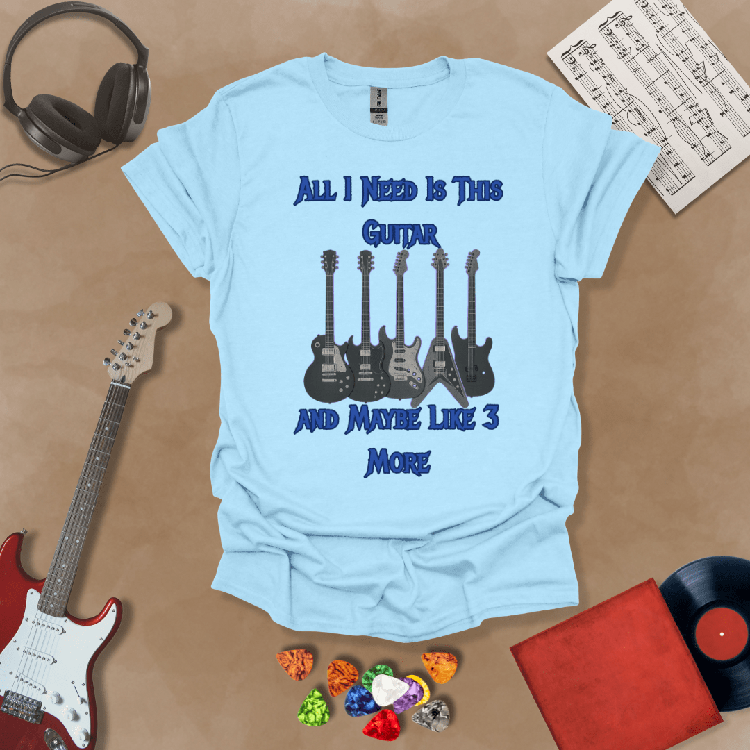 Light blue t-shirt with Row of five electric guitars with neon glow accents under bold blue text reading ‘All I Need Is This Guitar and Maybe Like 3 More,’ rock-inspired graphic t-shirt design