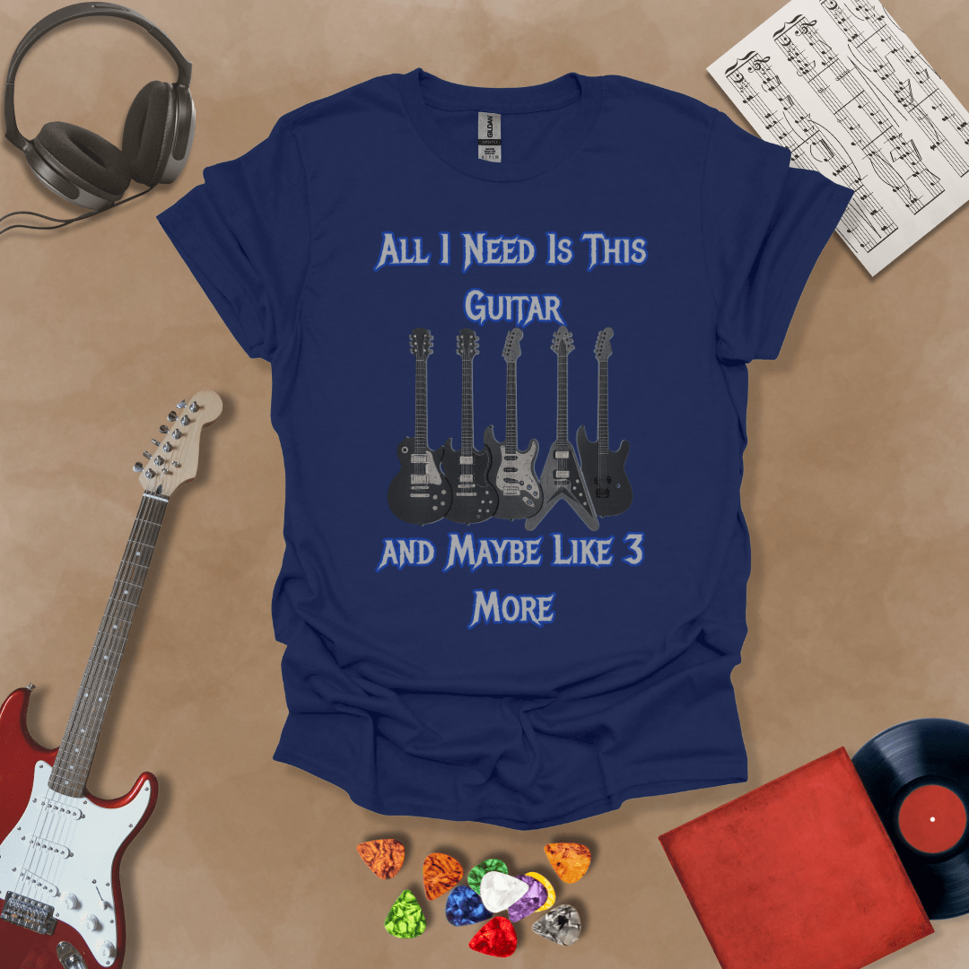 Navy t-shirt with Row of five electric guitars under bold blue text reading ‘All I Need Is This Guitar and Maybe Like 3 More,’ rock-inspired graphic t-shirt design