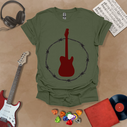 Green t-shirt with Blood-red electric guitar glowing inside a circle of metallic barbed wire, bold rock graphic for dark shirts.