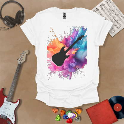 White t-shirt with Black electric guitar silhouette bursting through vibrant paint splash explosion in orange, pink, purple, and blue, abstract art tee design.