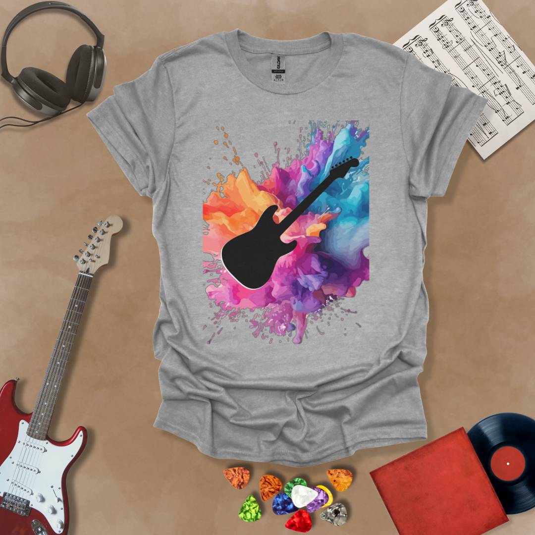 Gray shirt with Black electric guitar silhouette bursting through vibrant paint splash explosion in orange, pink, purple, and blue, abstract art tee design.
