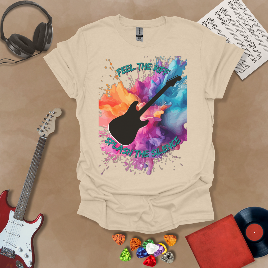 Beige T-shirt with Bold guitar splash design with black silhouette and colorful paint burst, outlined for contrast. Text reads ‘Feel the Riff, Splash the Silence'.