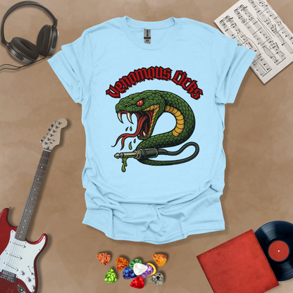 Light Blue t-shirt with graphic of Green snake striking with fangs bared, wrapped around a guitar cable plug, dripping venom, bold gothic red “Venomous Licks” text above.