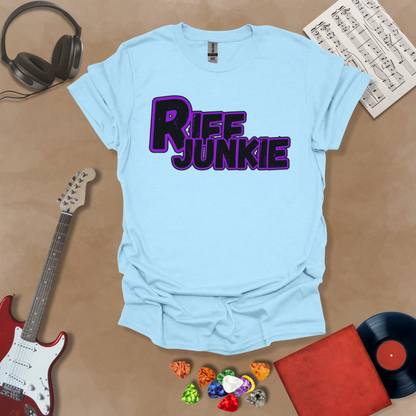 Light blue T-shirt with Riff Junkie Logo T-Shirt in Stage Light Edition featuring purple-outlined logo on light background, artistic glow design inspired by stage lighting.